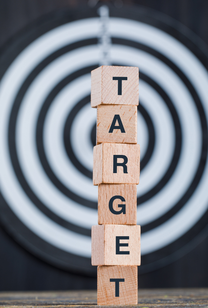 business-target-concept-with-dartboard-wooden-cubes-wooden-black-background-side-view